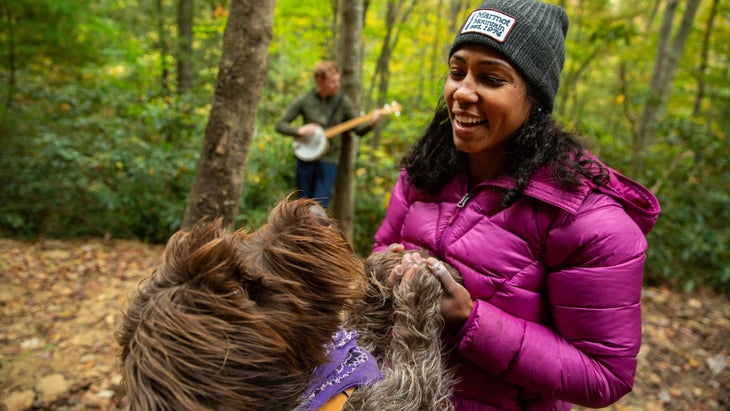 woman playing with dog in daniel boone national forest