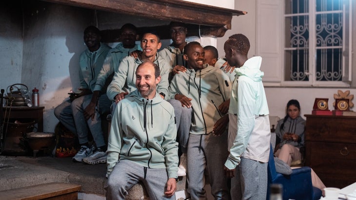 A group of runners in a kitchen and smiling