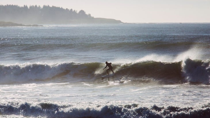 A surfer catches a barrel off Higgins Beach, Maine, while a new set of waves comes in.