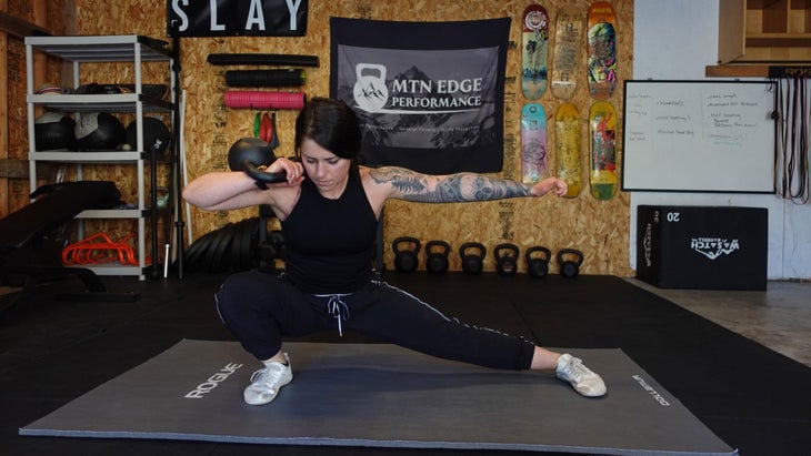 Woman demonstrates a side lunge for a ski workout