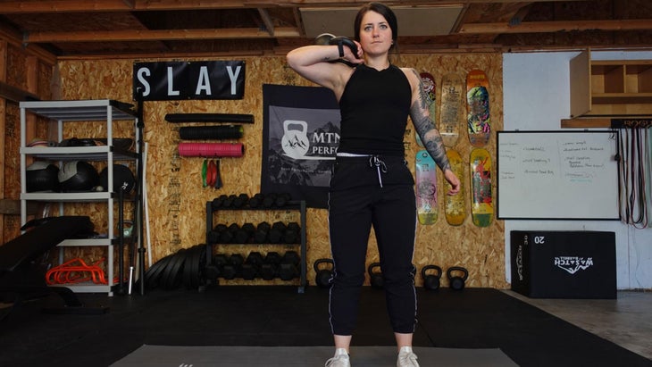 Woman demonstrates a lunge for a ski workout