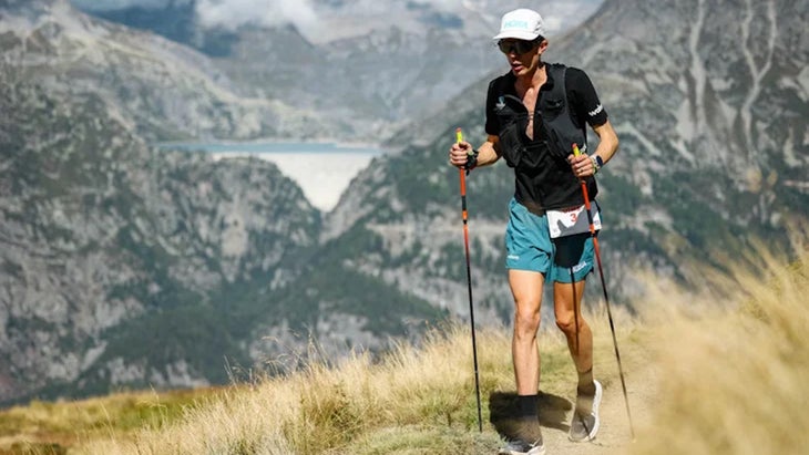 a man runs with poles in a mountain environment