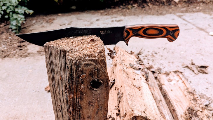 knife embedded into a piece of dry firewood