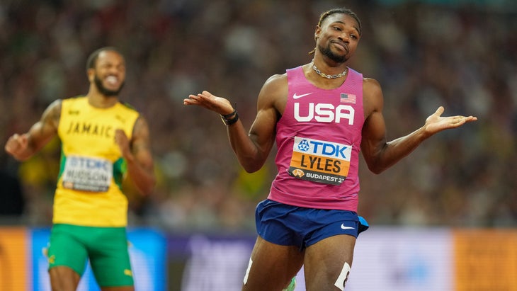 A runner wears a red shrug as he takes first place