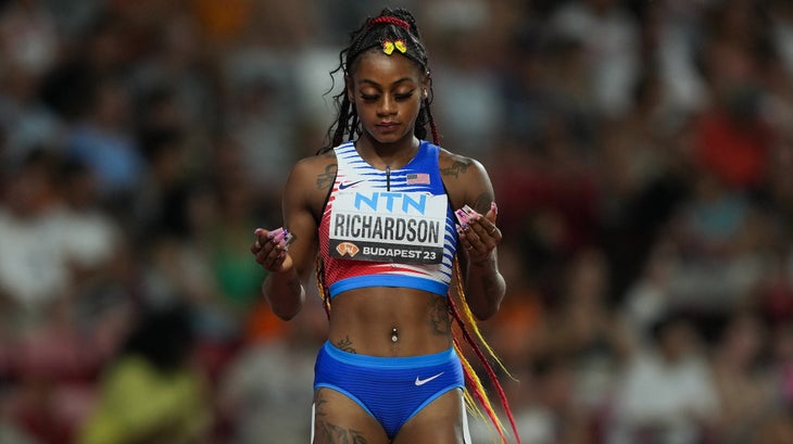 a woman stands on a track and focuses