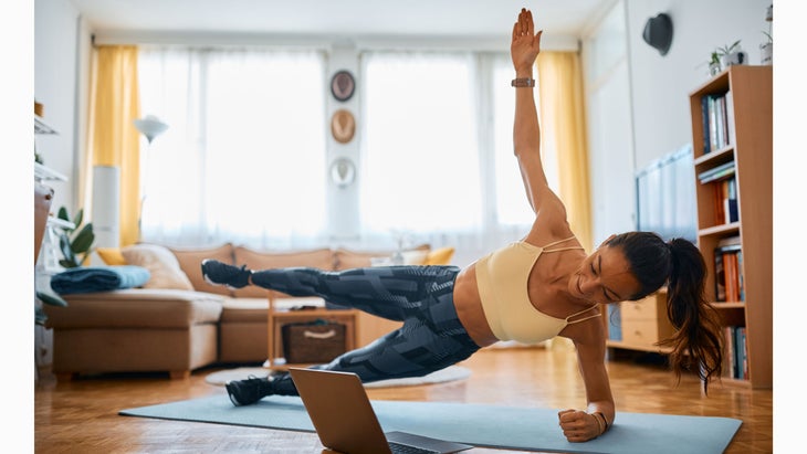 Woman does a leg lift in a side plank position