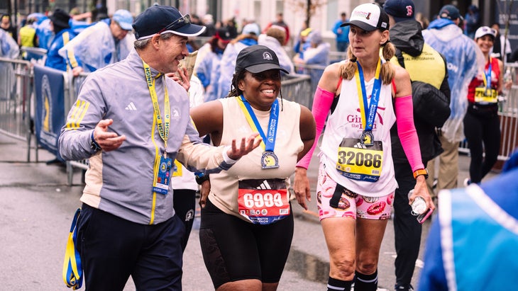 A woman finishes the Boston Marathon and smiles