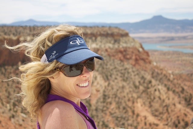 The author, wearing sunglasses and a visor, with a view of Kitchen Mesa, New Mexico in the background