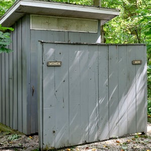 A pristine outdoor toilet serves as a reminder to never try to save something from inside the vault.