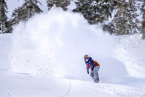 Man snowboarding in powder