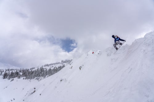 Man airing off a lip on a snowboard