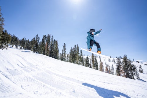 Woman does an air on a snowboard