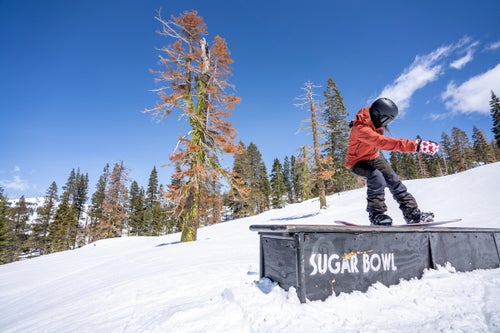 Woman on a box on a snowboard