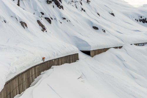 Man does a big drop on a snowboard