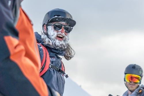 Man with snow in his beard smiling