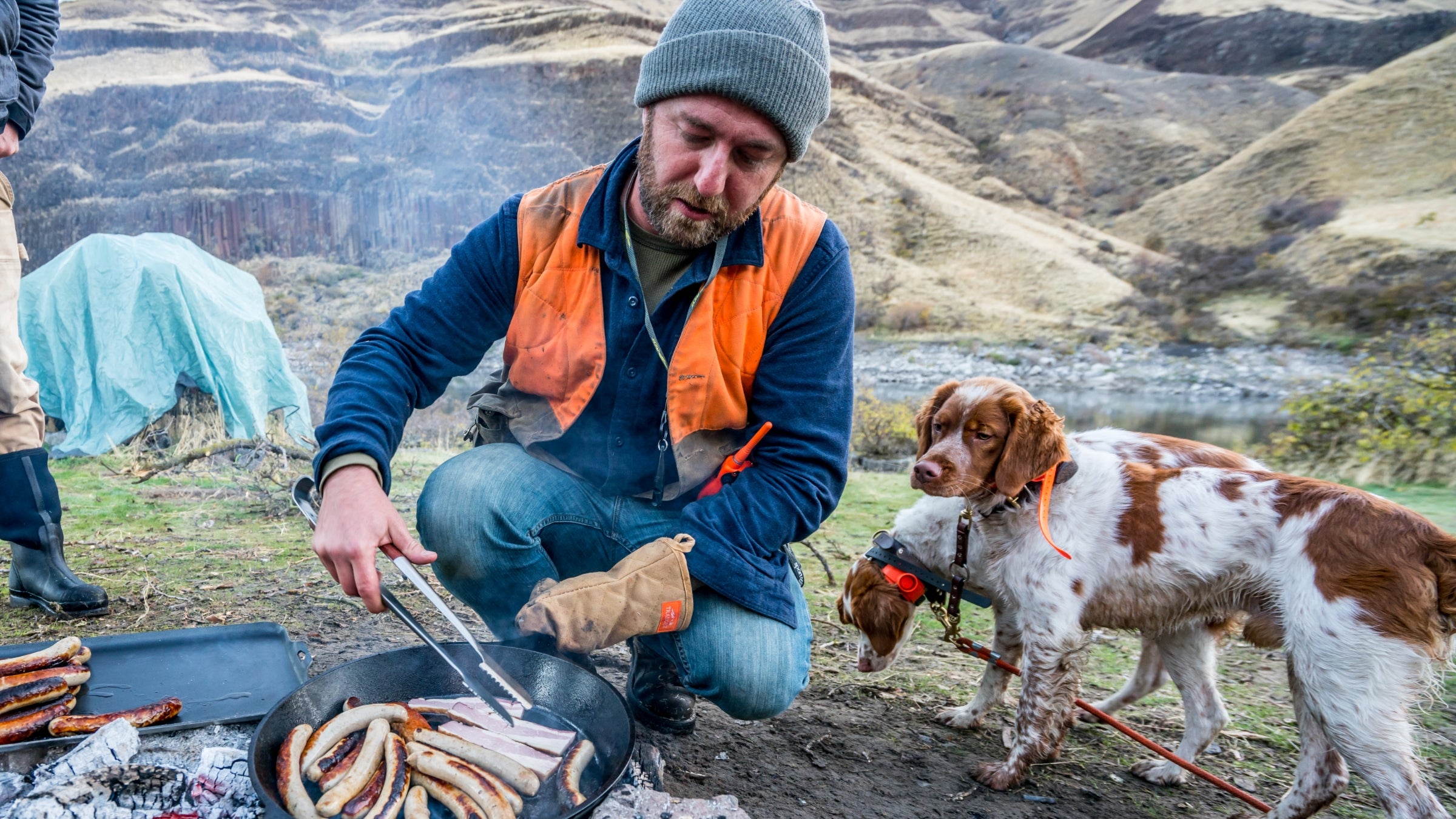 Elias Cairo cooking over a campfire
