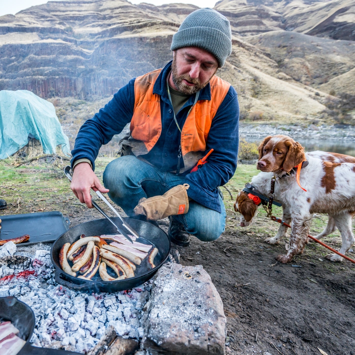 Elias Cairo cooking over a campfire