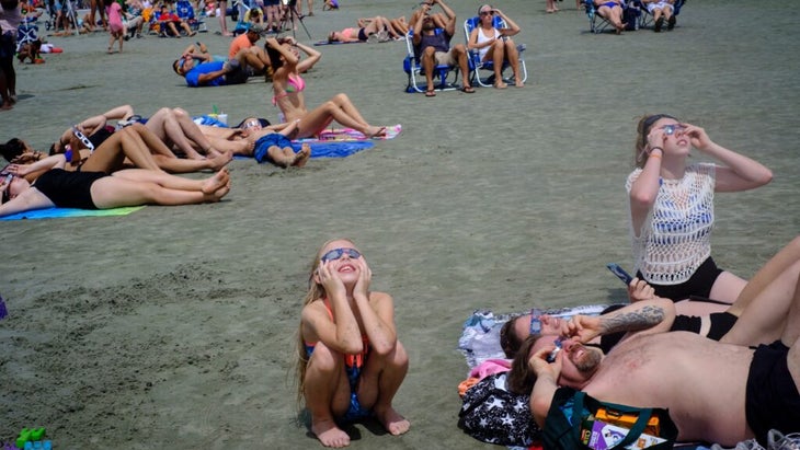 Beach-goers in South Carolina wearing their special glasses to watch the previous total solar eclipse, in August 2017