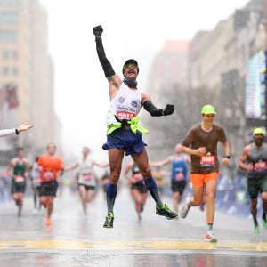A man celebrates after crossing the finish line at the Boston Marathon