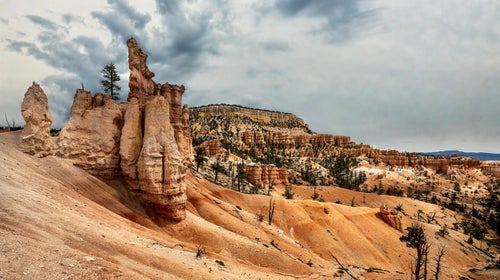 Red and orange desert canyon with blue sky in background