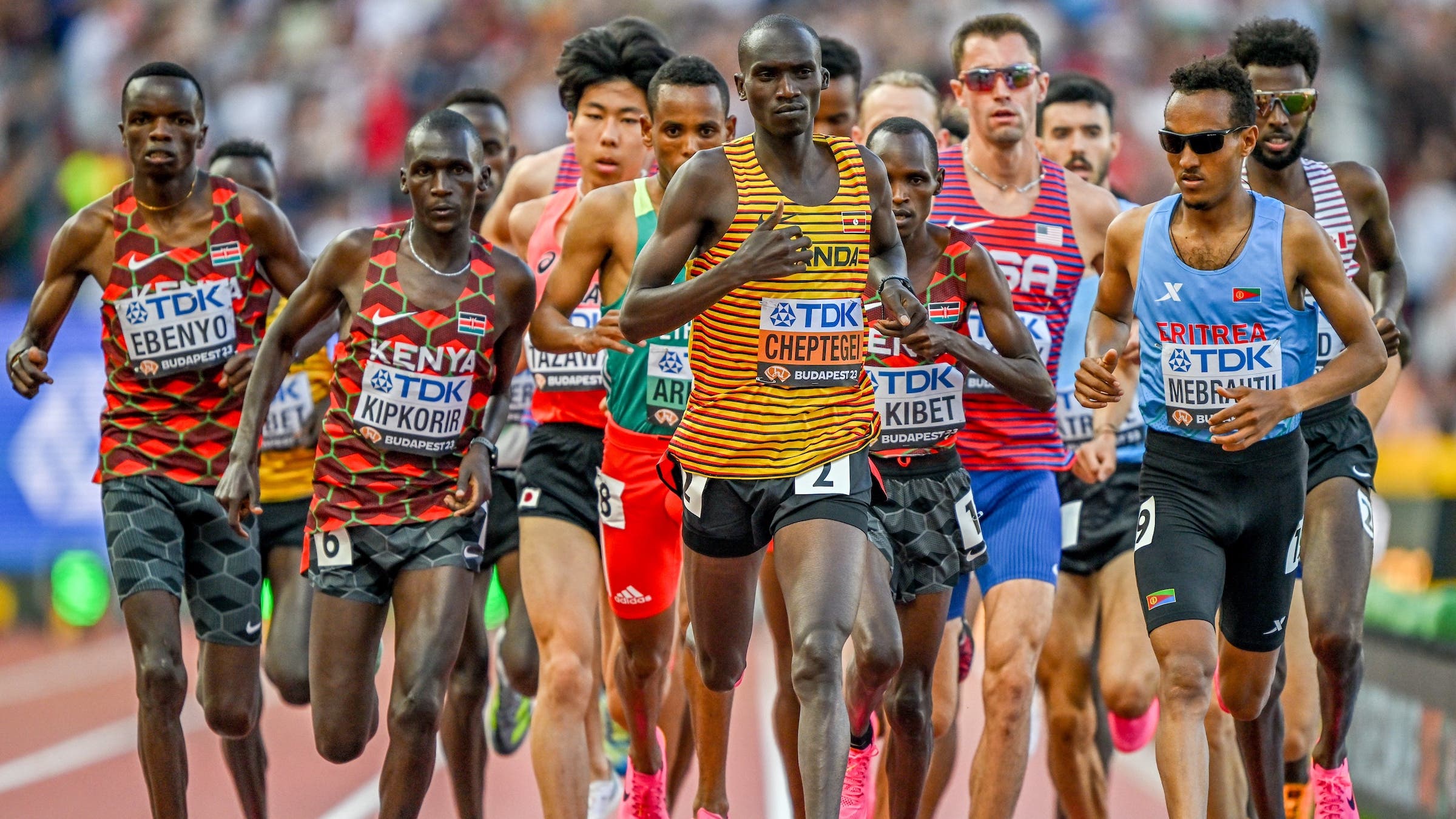 A pack of elite runners together on a track