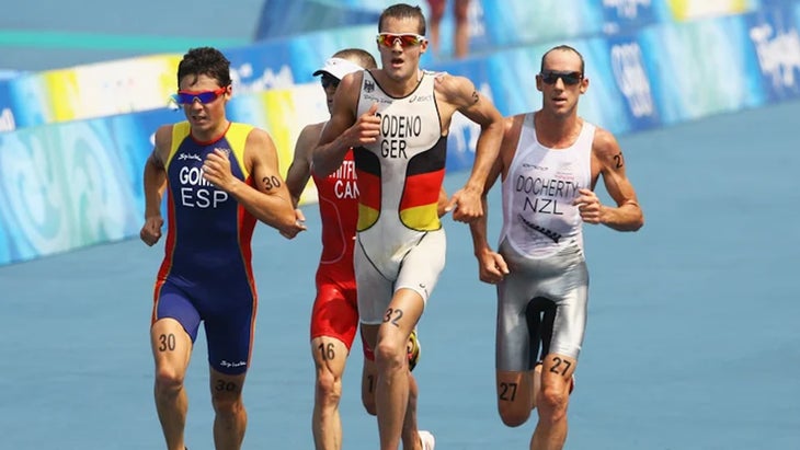 four men run together during an ironman