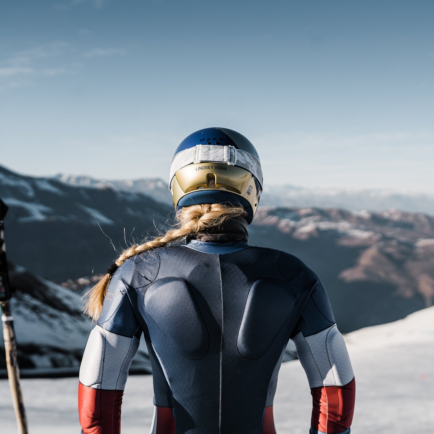 The back of Lindsey Vonn as she stares down a mountain.