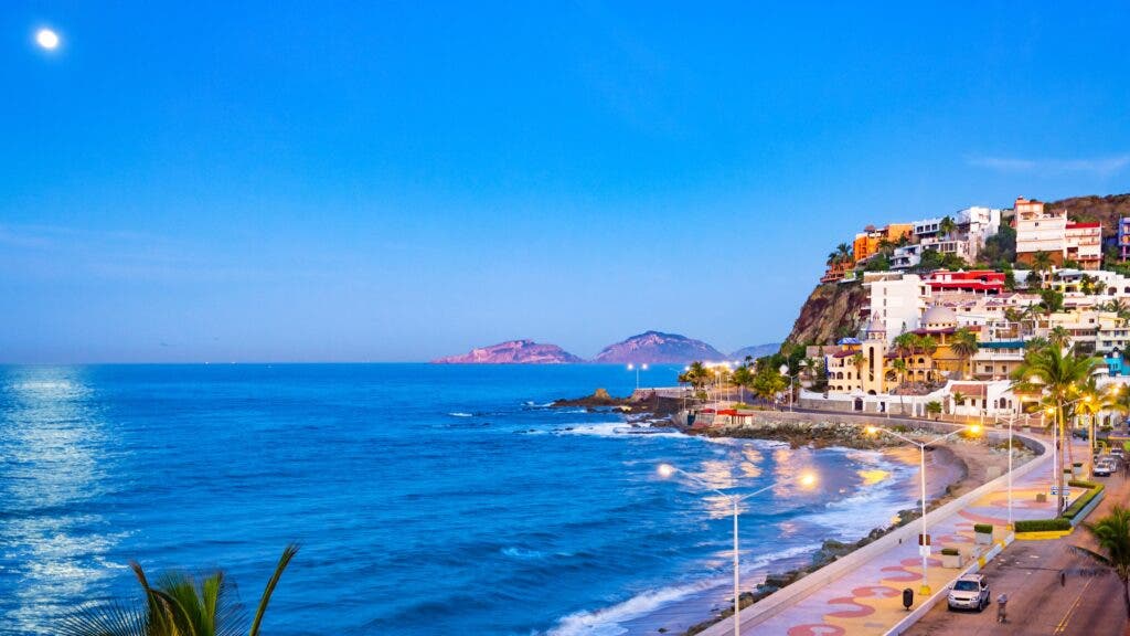 The waterfront of Mazatlan, Mexico, in early evening, with the moon reflecting on the water