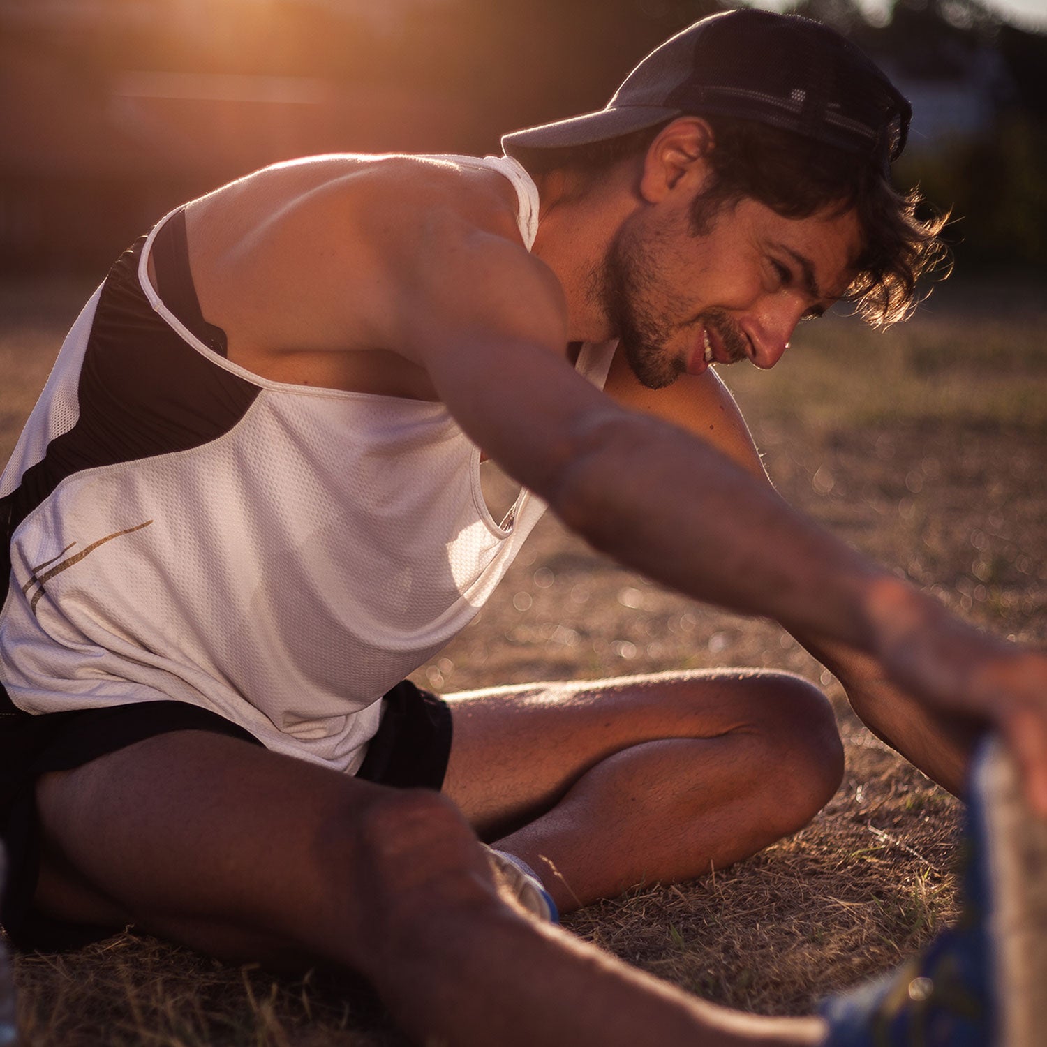 young man of color stretching after a run