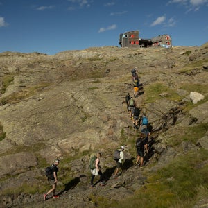 Several runners work their way to a cabin in the mountains