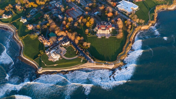 An aerial shot of the grand Gilded Age homes along Newport, Rhode Island's Cliff Walk