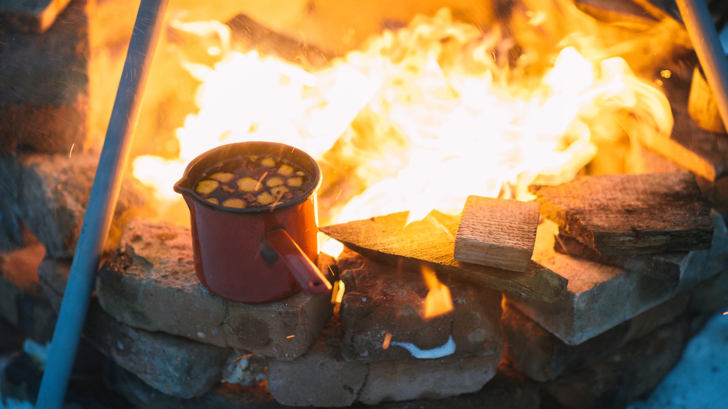 Drink sitting next to a campfire