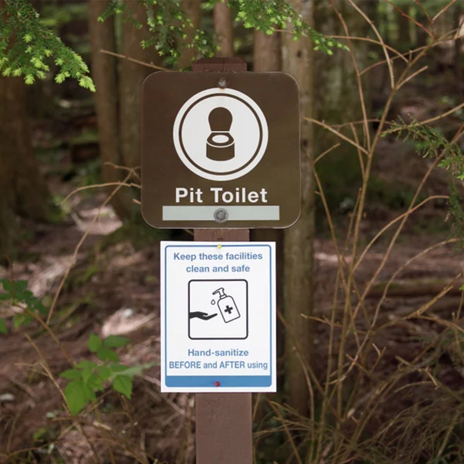 Sign in front of pit toilet