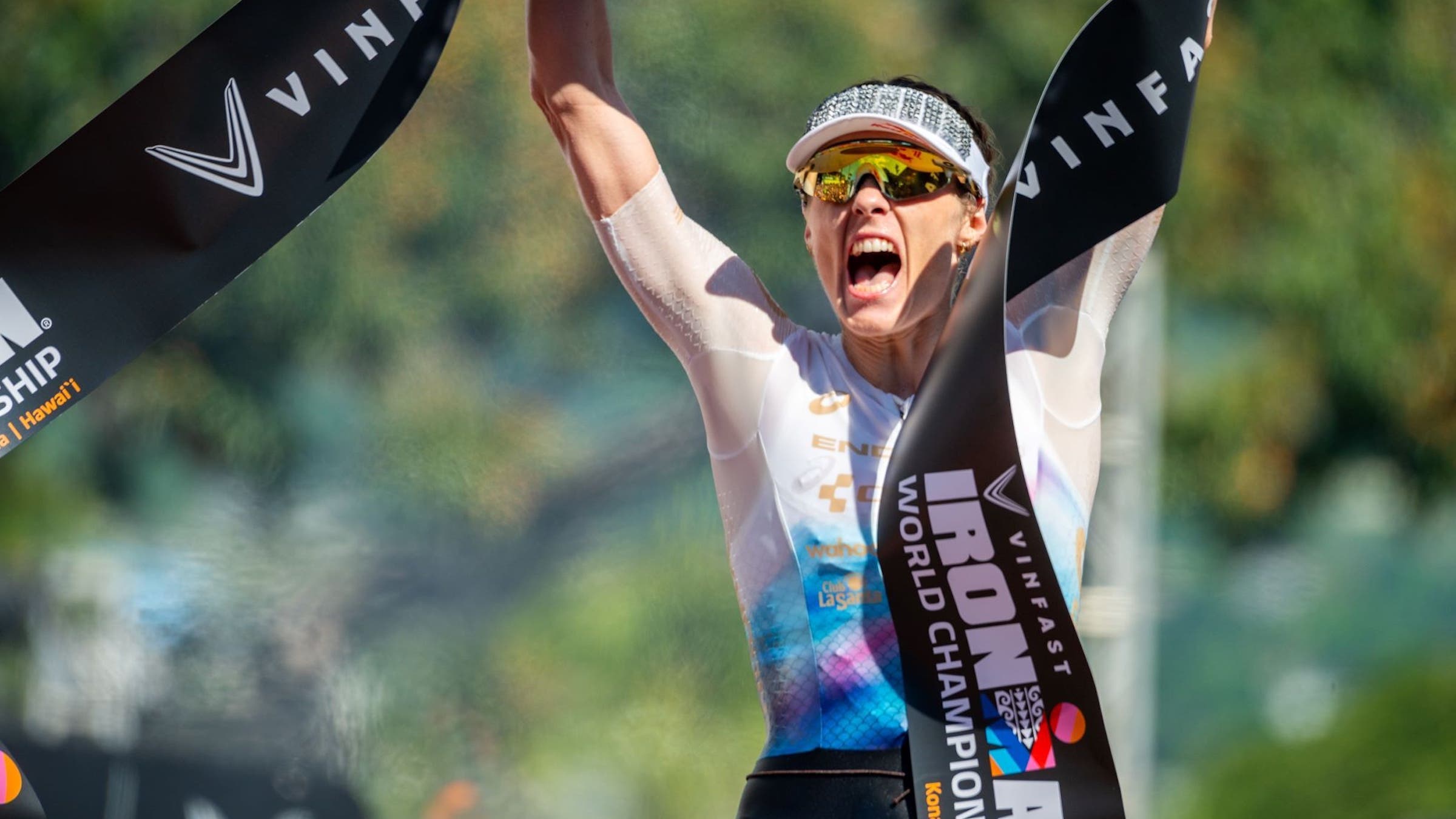 woman wins the Ironman with a white shirt on