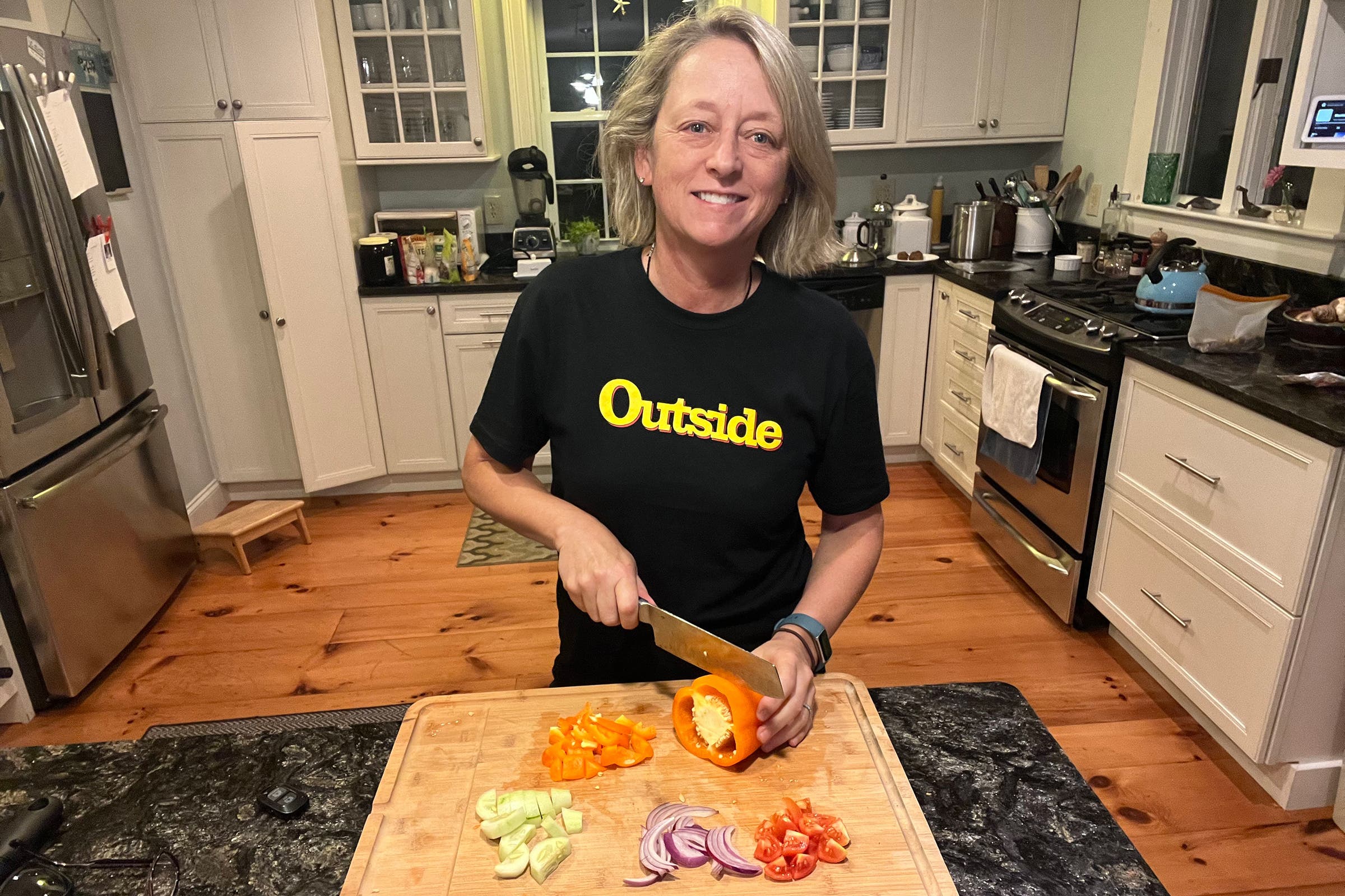 The author chopping on her wood cutting board to avoid microplastic shedding.