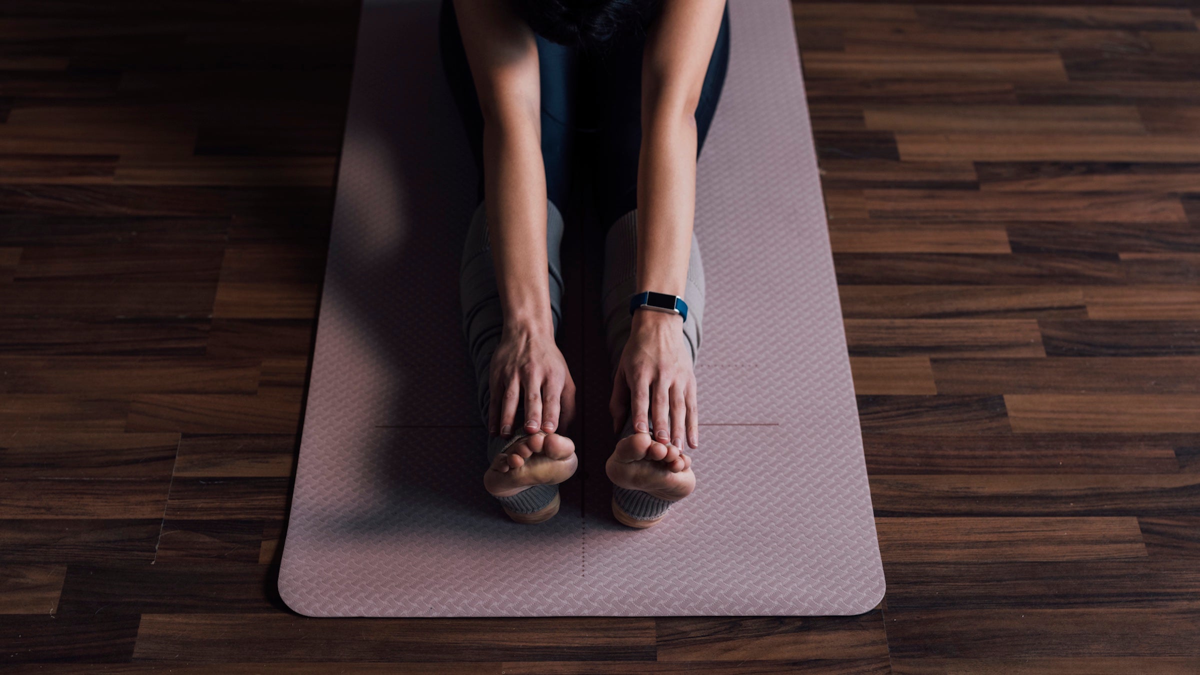 An Anonymous Young Woman Stretching at Home