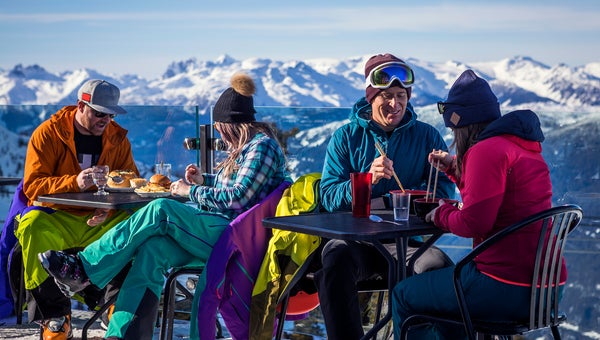 Skiers having drinks at the top during their ski vacation in Whistler, Canada.