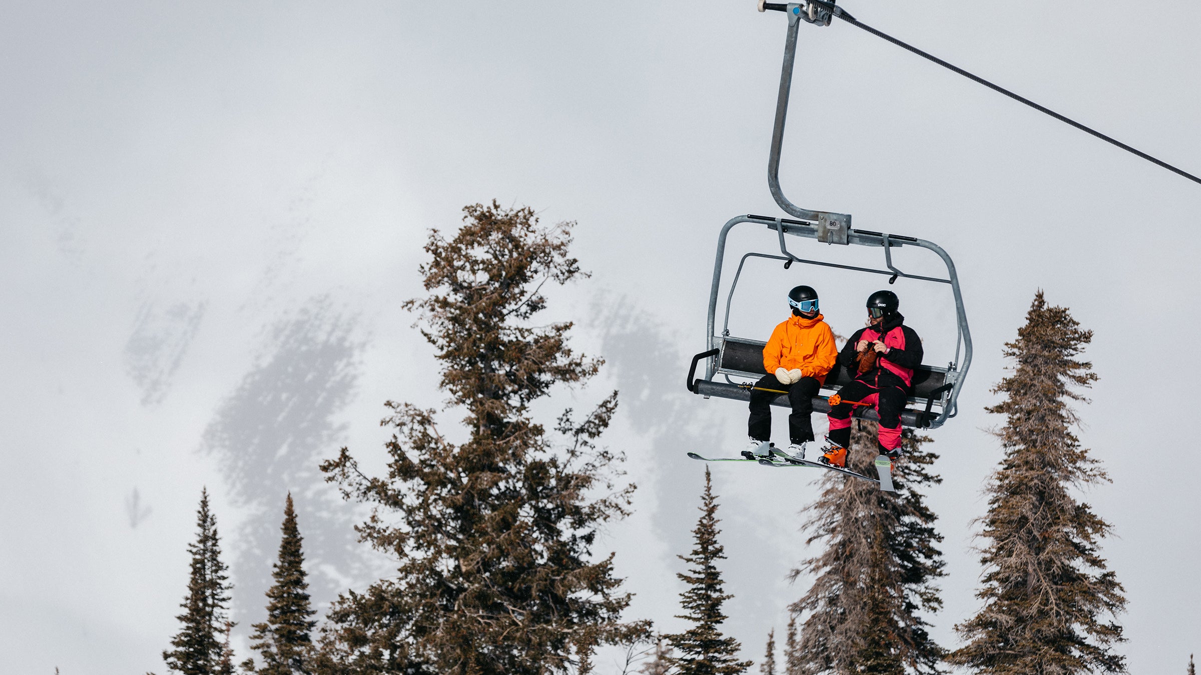 Men wearing jackets on a chairlift during the ski test