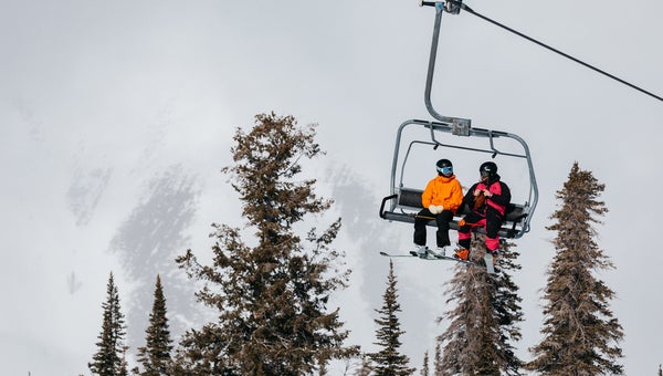 Men wearing jackets on a chairlift during the ski test