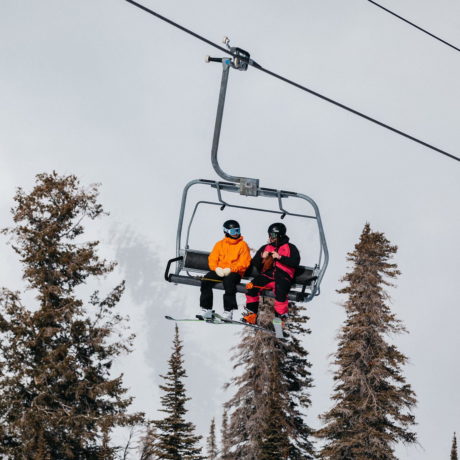 Men wearing jackets on a chairlift during the ski test