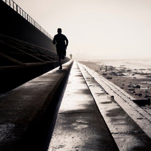 A man runs by the beach