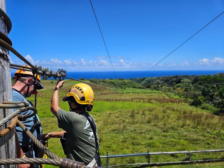 woman setting up zipline in Hawaii