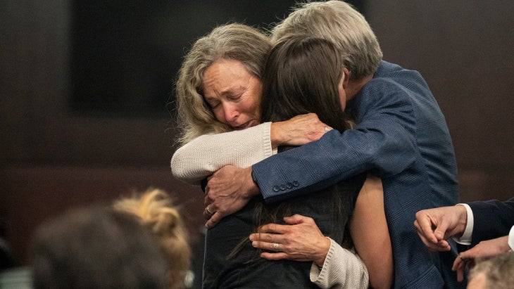 Moriah Wilson’s parents embrace Caitlin Cash, one of Wilson’s close friends. 