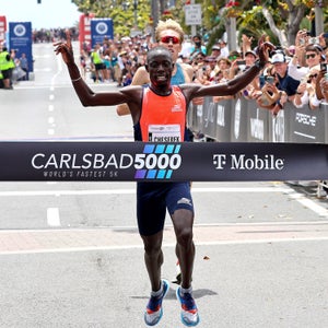 A man crosses the finish line of a 5K