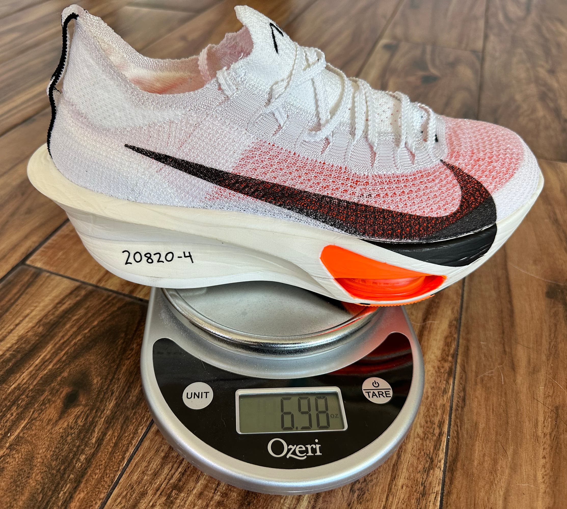 Nike Alphafly 3 on a scale reading 6.98 ounces