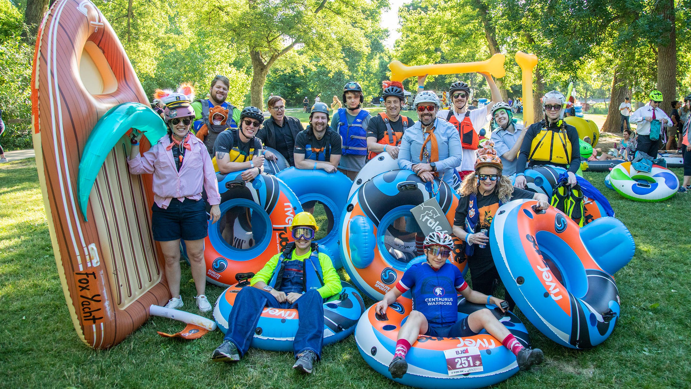 Rule 4 employees show off their inflatable rafts during a boating outing.