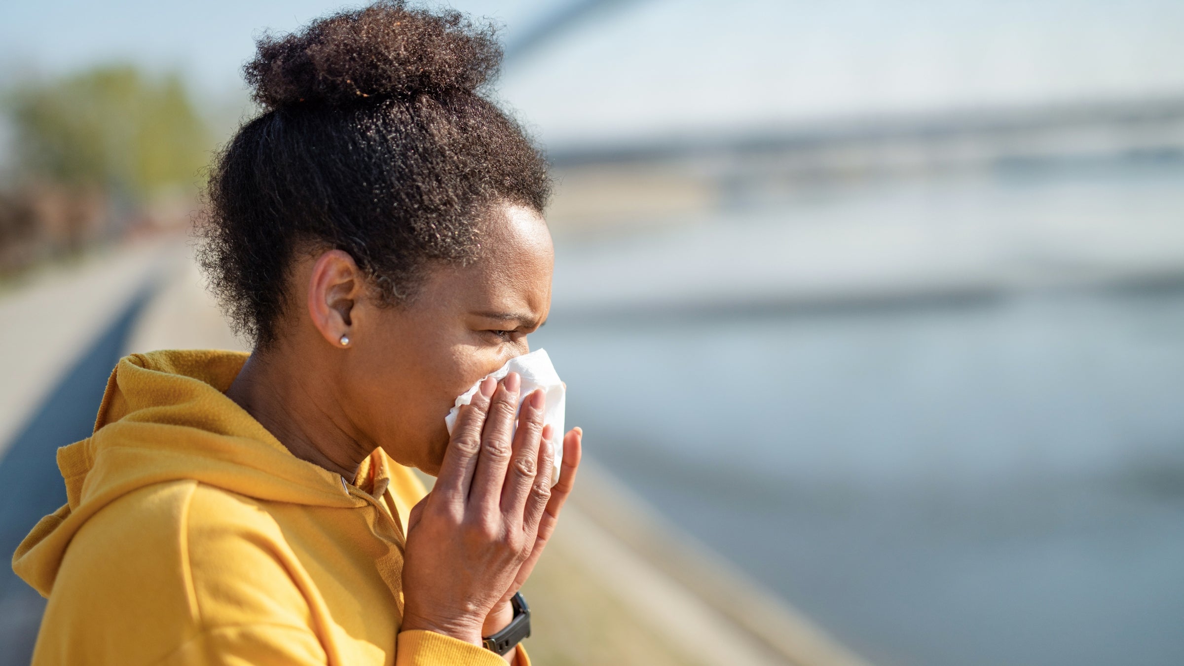 African American mid adult woman sneezing.