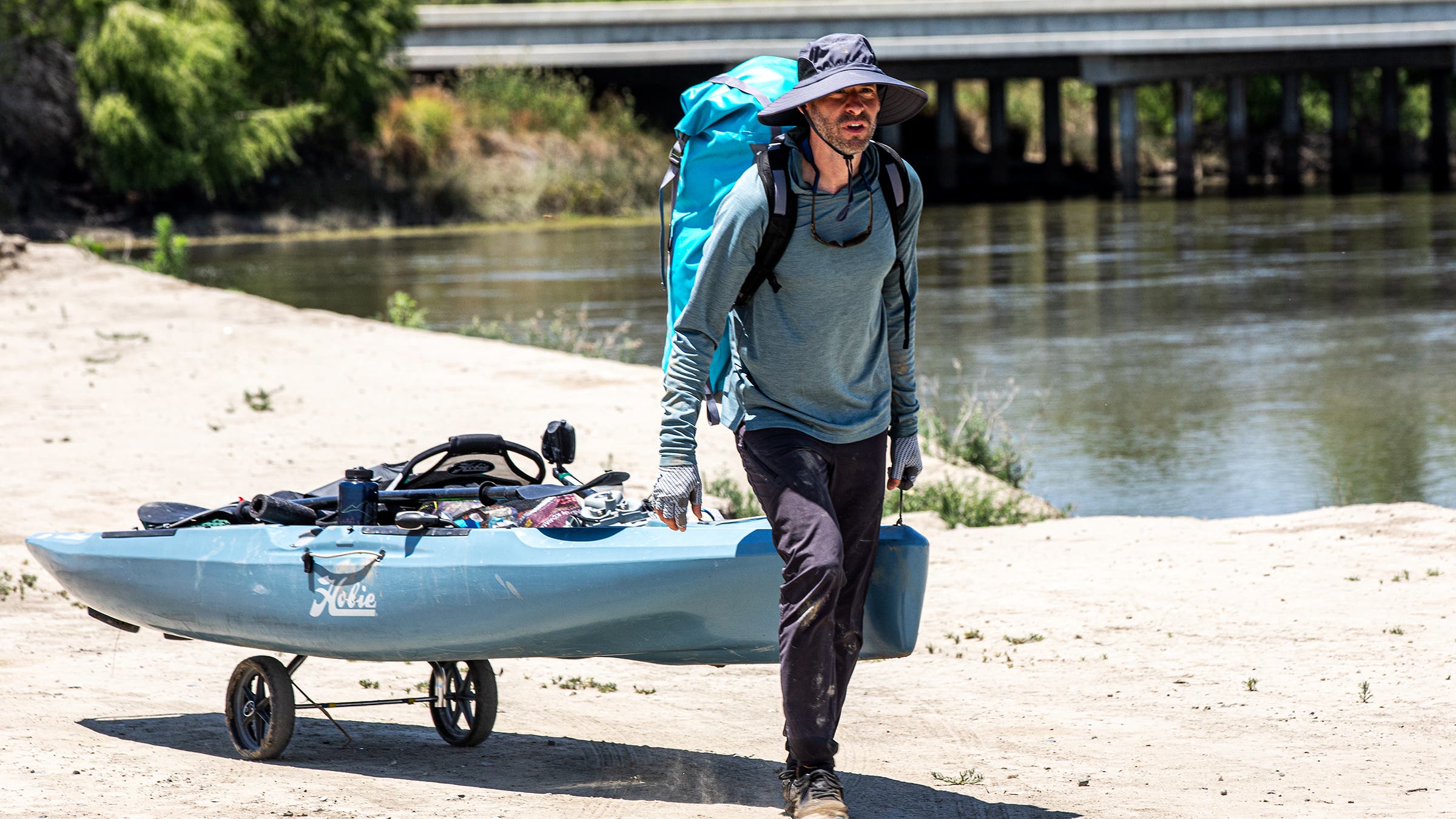 The author wheeling his pedal-driven kayak around a series of dams at the northern end of Tulare Lake