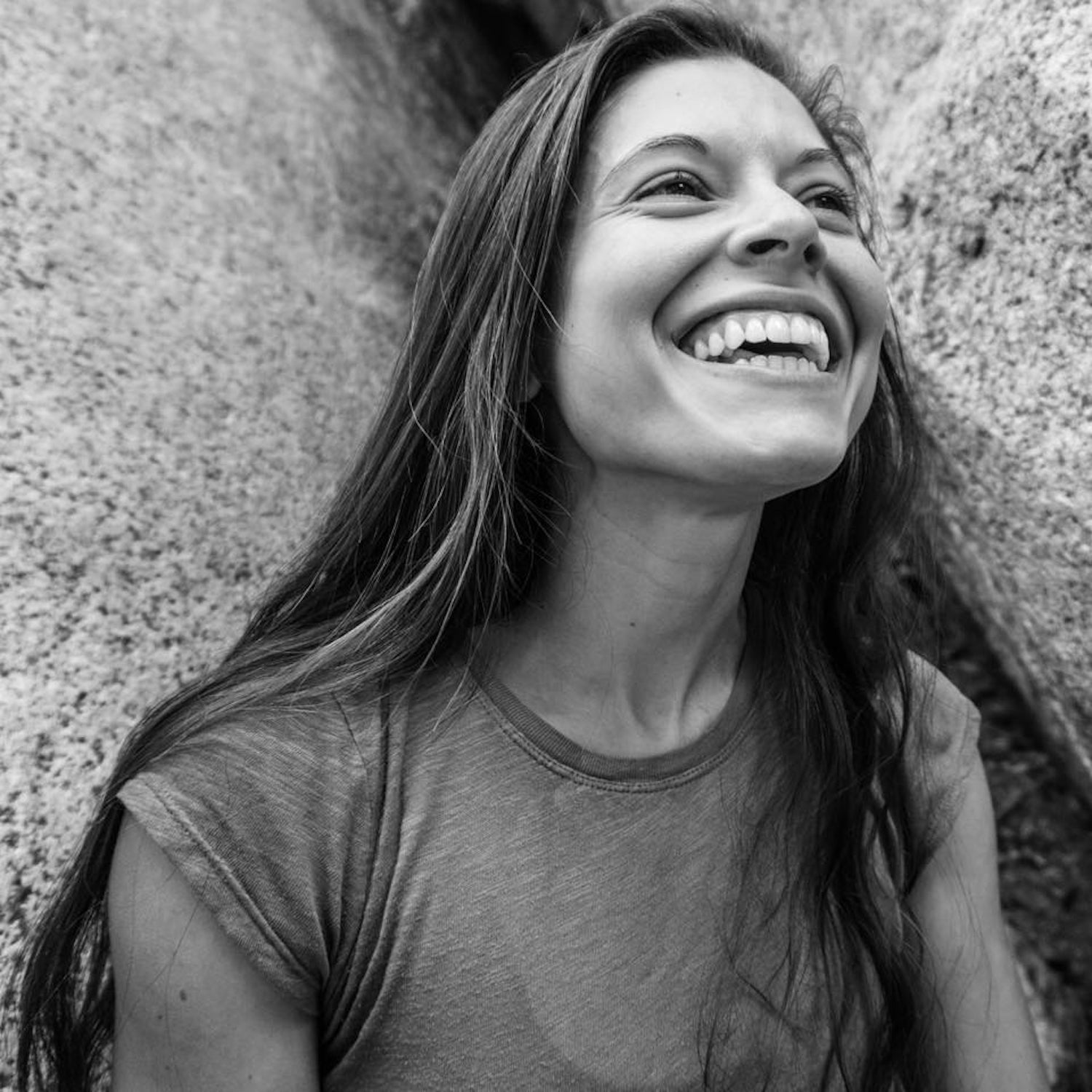 A black and white photo of a woman smiling