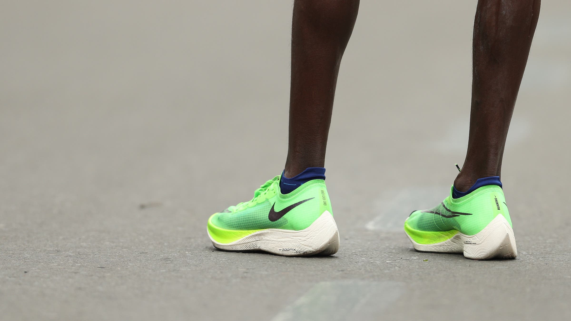 A shot of legs and green super shoes for a marathon